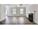 Living room featuring a fireplace, hardwood flooring, and ample natural light at 5380 Bridle Point Pkwy, Snellville, GA 30039