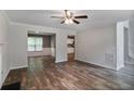 Open-concept layout featuring hardwood flooring and neutral walls connecting the living room and dining area at 5380 Bridle Point Pkwy, Snellville, GA 30039