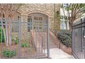 Exterior shot of the building entrance with brick stairs and a stone facade at 625 Piedmont Ne Ave # 105, Atlanta, GA 30308