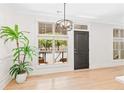 Bright living room with hardwood floors, large windows, and modern lighting fixture at 625 Piedmont Ne Ave # 105, Atlanta, GA 30308