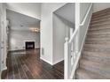 Inviting entryway featuring wood-look tile floors, staircase, and an open view into the living room at 1086 Erie Cir, Stone Mountain, GA 30087