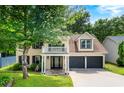 Charming two-story home features a balcony, well-maintained lawn, and a two-car garage at 1086 Erie Cir, Stone Mountain, GA 30087