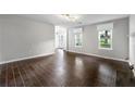 Bright living room featuring wood-look tile floors, a fireplace, and large windows at 1086 Erie Cir, Stone Mountain, GA 30087