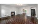 Spacious living room with a cozy fireplace, wood-look tile floors and ample natural light at 1086 Erie Cir, Stone Mountain, GA 30087