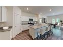 Modern kitchen featuring white cabinets, granite countertops, and stainless steel appliances at 206 Silverton Dr, Dacula, GA 30019