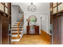 Bright foyer with hardwood floors, staircase with iron railing, and a classic chest at 2892 Guinevere Ne Dr, Atlanta, GA 30345
