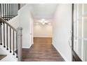 Bright entryway with hardwood floors, staircase with iron balusters and neutral wall paint at 3514 Ambassador Aly, Scottdale, GA 30079