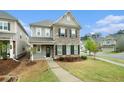 Beautiful two-story home boasting manicured lawn and inviting walkway in a suburban neighborhood at 3514 Ambassador Aly, Scottdale, GA 30079