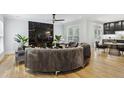 Bright living room featuring a black marble fireplace, sleek furniture, and hardwood flooring at 560 Morgan Ne St, Atlanta, GA 30308