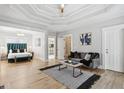 Spacious main bedroom with a tray ceiling, hardwood floors, and a seating area at 560 Morgan Ne St, Atlanta, GA 30308