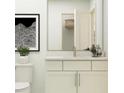 Bathroom showcasing a toilet, vanity with cabinet storage, decor, and framed artwork at 811 Atkins Ln, Woodstock, GA 30188