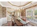 Traditional dining room with decorative wall paper, chandelier, and large window at 105 Pine Valley Ct, Hiram, GA 30141
