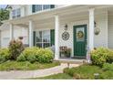 Charming home featuring a welcoming front porch with swing and landscaped garden at 105 Pine Valley Ct, Hiram, GA 30141