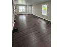 Spacious living room featuring dark wood floors and neutral walls with an entry and large windows at 15 Harlan Rd, Atlanta, GA 30311