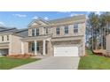 Attractive brick two-story home with a front porch, manicured lawn, and a two-car garage at 619 Leafy Branch Way, Mcdonough, GA 30253