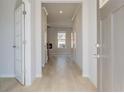 Inviting foyer showcasing hardwood floors, neutral paint, and a view to the living area at 619 Leafy Branch Way, Mcdonough, GA 30253