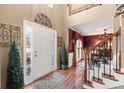 Grand foyer with hardwood floors, a staircase, and views into the dining room at 154 Hunters Trl, Dallas, GA 30157