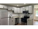Updated kitchen with stainless steel appliances, granite countertops, and new cabinets at 38 Royce Dr, Jonesboro, GA 30238