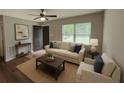 Inviting living room with hardwood floors, a comfortable sofa, and plenty of natural light at 38 Royce Dr, Jonesboro, GA 30238