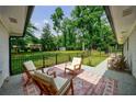 Inviting back porch features comfortable seating and serene views of the expansive, fenced backyard at 1600 Donna Sw St, Mableton, GA 30126