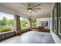 Inviting covered front porch featuring stone columns, a porch swing, and a ceiling fan at 2056 Hosea L Williams Ne Dr, Atlanta, GA 30317