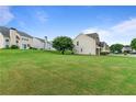 Expansive backyard with lush green grass and mature trees, perfect for outdoor activities at 8970 Ruel Ln, Suwanee, GA 30024