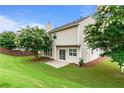 Beautiful backyard with a patio, lawn, and mature trees, ideal for relaxation and outdoor enjoyment at 8970 Ruel Ln, Suwanee, GA 30024