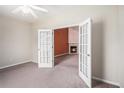 Carpeted bedroom with french doors leading to a room with fireplace, creating a cozy ambiance at 4200 Vinca Way, Union City, GA 30291