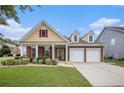 Charming two-story home features a two-car garage, manicured lawn, and beautiful landscaping at 4200 Vinca Way, Union City, GA 30291