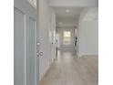 Bright foyer with hardwood floors, neutral walls, and natural light from nearby windows at 640 Leafy Branch Way, Mcdonough, GA 30253