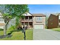 Traditional style brick home with a covered porch and well-manicured lawn at 1610 Apollo Dr, Suwanee, GA 30024