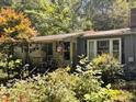 A charming single-story home with a covered porch and surrounded by lush greenery at 3617 Bob White Ln, Loganville, GA 30052