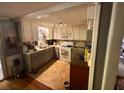 Traditional kitchen with white cabinets, laminate countertops, and essential appliances at 3617 Bob White Ln, Loganville, GA 30052
