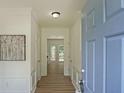 Inviting home entryway with light walls, hardwood floors, decorative moldings, and a lovely piece of art at 405 Rosedown Way, Lawrenceville, GA 30043