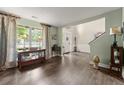 Bright living room featuring hardwood floors, large windows, and stylish decor, enhancing its welcoming ambiance at 5885 Millstone Dr, Cumming, GA 30028