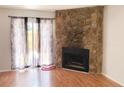 Living room featuring a stone fireplace and sliding doors to the patio at 6658 Ramsgate Way, Norcross, GA 30093