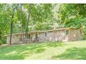 Single-story home with a stone facade, front porch and lush green lawn with mature trees at 109 Amberidge Nw Dr, Cartersville, GA 30121