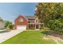 Home's front yard, highlighting the well-maintained lawn and brick exterior at 2479 Mitford Ct, Dacula, GA 30019