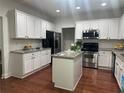 Spacious kitchen features white cabinetry, granite counters, and stainless steel appliances at 2479 Mitford Ct, Dacula, GA 30019