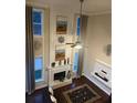 Living room with a fireplace, tall windows and hardwood floors at 2479 Mitford Ct, Dacula, GA 30019