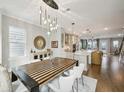 Elegant dining room flows into a modern kitchen, with a long island, stainless appliances and a large custom table at 522 Hargrove Ln, Decatur, GA 30030