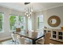 Well-lit dining area boasts a modern chandelier, round mirror, and stylish decor with hardwood floors at 522 Hargrove Ln, Decatur, GA 30030