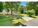 Exterior view of a home with a spacious driveway, three-car garage, and well-maintained grounds at 5971 Dogwood Se Dr, Acworth, GA 30102
