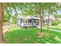 Inviting home with manicured lawn and a charming porch, nestled among mature trees at 1253 Lucile Sw Ave, Atlanta, GA 30310