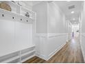 Bright hallway featuring sleek wood floors and a built-in storage bench at 1253 Lucile Sw Ave, Atlanta, GA 30310