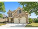 Well-maintained home showcasing the side view, two car garage, and landscaping at 585 Lawton Bridge Sw Rd, Smyrna, GA 30082
