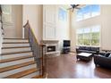 Spacious living room with large windows, fireplace, and hardwood floors at 585 Lawton Bridge Sw Rd, Smyrna, GA 30082