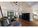 Inviting living room features vaulted ceilings, fireplace, hardwood floors, and a comfortable sectional sofa at 6455 Ivey Meadow Ln, Cumming, GA 30040