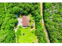 Expansive property featuring a home with a sprawling lawn and surrounded by lush greenery and trees at 6919 Mount Zion Rd, Waco, GA 30182