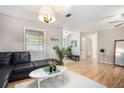 Spacious living room features hardwood floors, modern furnishings, and large windows for natural light at 8740 Roswell Rd # 2G, Atlanta, GA 30350
